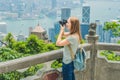 Young woman taking photos of victoria harbor in Hong Kong, China Royalty Free Stock Photo