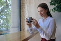 Young woman taking picture at cafe. Creative hobby Royalty Free Stock Photo