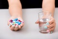 Young woman taking pill or drug with glass of water, Royalty Free Stock Photo