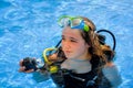 Young woman taking a scuba diving lesson in a resort pool Royalty Free Stock Photo