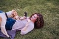 young woman taking a selfie with mobile phone with her dog at the park. autumn season Royalty Free Stock Photo