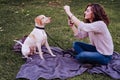 young woman taking a selfie with mobile phone with her dog at the park. autumn season Royalty Free Stock Photo