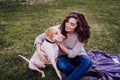 young woman taking a selfie with mobile phone with her dog at the park. autumn season Royalty Free Stock Photo