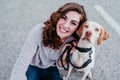 young woman taking a selfie with mobile phone with her dog at the street. autumn season Royalty Free Stock Photo