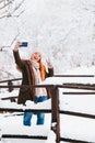 Young woman taking a selfie in a park in winter Royalty Free Stock Photo