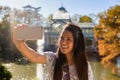 Young woman taking a selfie in Retiro park, Madrid