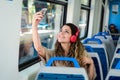 Young woman taking a selfie on train with her phone Royalty Free Stock Photo