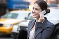 Young Woman Talking on Cell Phone by Yellow Taxi Royalty Free Stock Photo