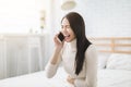 Young woman talking with friend on mobile phone and laughing Royalty Free Stock Photo