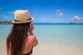 Young woman talking on her phone at tropical beach Royalty Free Stock Photo