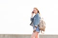 Young woman talking on mobile phone against the white sky on the mountain Royalty Free Stock Photo