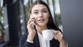 Young woman talking mobile phone and drinking coffee Royalty Free Stock Photo