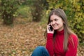 Young woman talking on mobile phone in fall Royalty Free Stock Photo