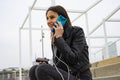 Woman talking on the phone while charging her mobile with the powerbank Royalty Free Stock Photo