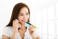 Young woman talking on the phone and showing credit card Royalty Free Stock Photo