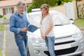 Young woman talking to instructor about drivers licence