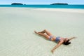 Young woman tanning on Aitutaki Lagoon Cook Islands