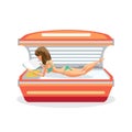 Young woman tanning in solarium and reading a book Royalty Free Stock Photo