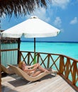 Young woman tans on a terrace .Maldives Royalty Free Stock Photo