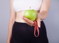 Young woman, tape measure and green apple Royalty Free Stock Photo