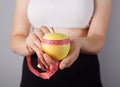 Young woman, tape measure and green apple Royalty Free Stock Photo