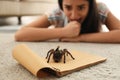 Young woman and tarantula. Arachnophobia fear of spiders