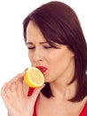 Young Woman Tasting a Bitter Lemon Royalty Free Stock Photo