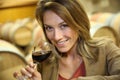 Young woman tasting red wine in wine cellar Royalty Free Stock Photo