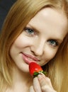 Young woman tasting strawberry Royalty Free Stock Photo