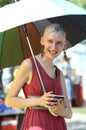 Young woman with a tattoo on the bald head holding an umbrella. Fest of Yoga and Vedic Culture