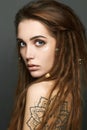 Young woman with tattoo and dreadlocks Royalty Free Stock Photo