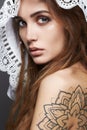 Young woman with tattoo,dreadlocks and lace shawl Royalty Free Stock Photo