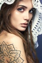 Young woman with tattoo,dreadlocks and lace shawl Royalty Free Stock Photo