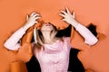 Young woman tearing to pieces a brown paper