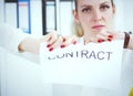 Angry woman tears agreement documents in front of camera closeup. Royalty Free Stock Photo