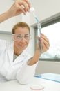young woman technician uses pipette in chemical lab