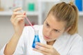 young woman technician uses pipette in chemical lab