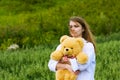 Young fashion woman with teddy bear walking outdoor Royalty Free Stock Photo