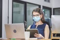 Young woman telephone operator with headset wear protection face mask against coronavirus, Customer service executive team working Royalty Free Stock Photo