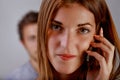 Young woman telephones and man listens to conversation