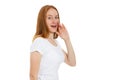 Young woman telling something, red head girl telling a secret. Portrait young happy woman who is calling to someone. Funny girl