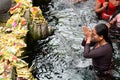 Young woman in the temple pond. Tirta Empul. Tampaksiring. Gianyar regency. Bali. Indonesia