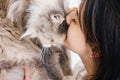 Young woman tenderly kisses her cat