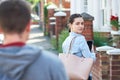 Young Woman Texting For Help On Mobile Phone Whilst Being Stalke