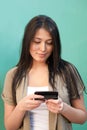 Young woman texting messages on mobile phone