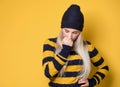 Young woman thinking. Closeup portrait of thoughtfully girl with confusion face expression, model wearing woolen cap and sweater,