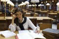 Young woman thinking in library Royalty Free Stock Photo