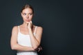 Young woman thinking and looking aside on gray banner background with copy space Royalty Free Stock Photo