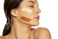 Young woman with three different tones of liquid foundation on her face Royalty Free Stock Photo