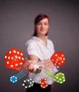 Young woman throwing dices and chips Royalty Free Stock Photo